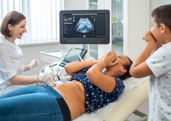 Woman having an ultrasound with shocked son