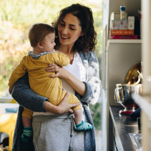 Mother holding baby in arms in a kitchen