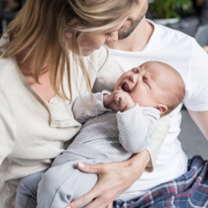 mother holding crying baby