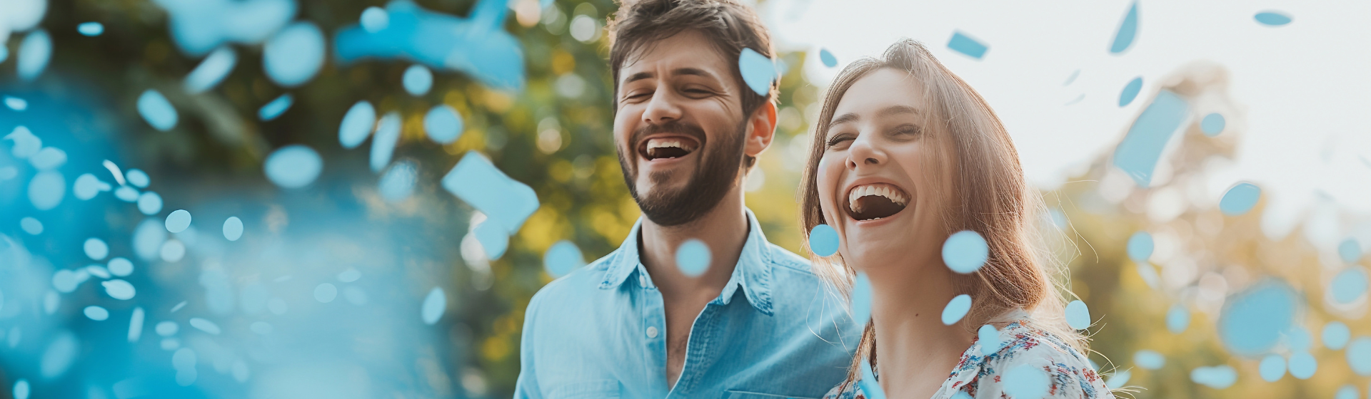 Couple smiling with blue confetti
